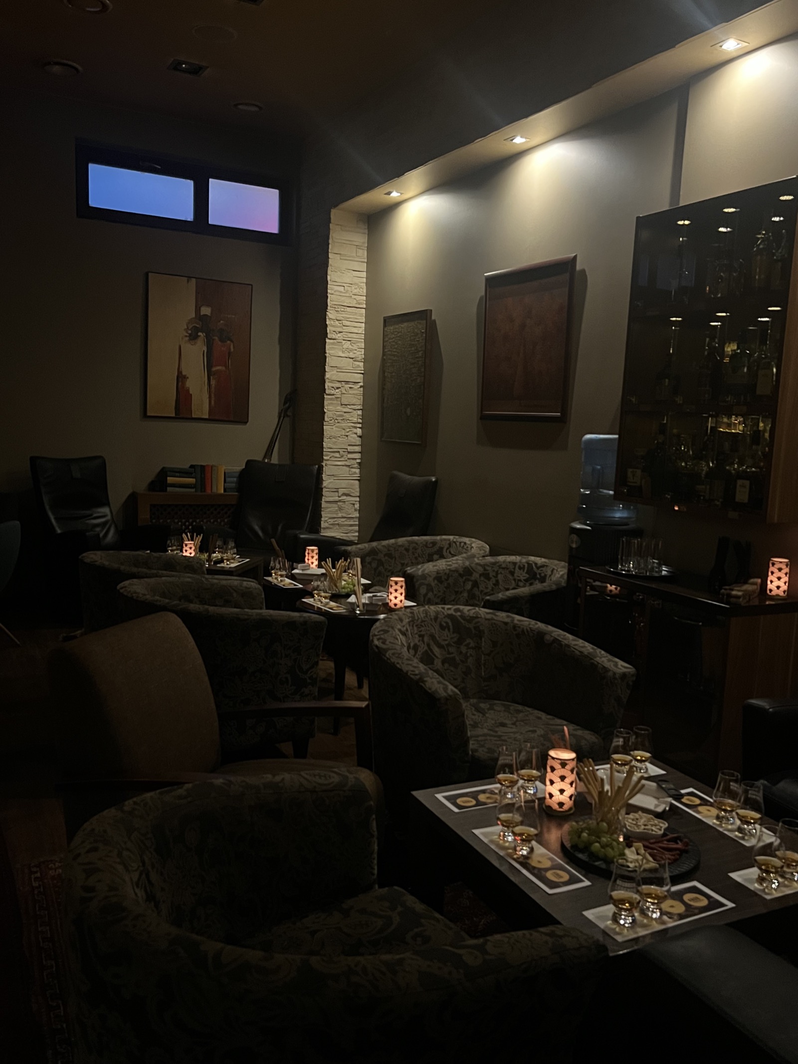 Tables set for a tasting in the lounge at night