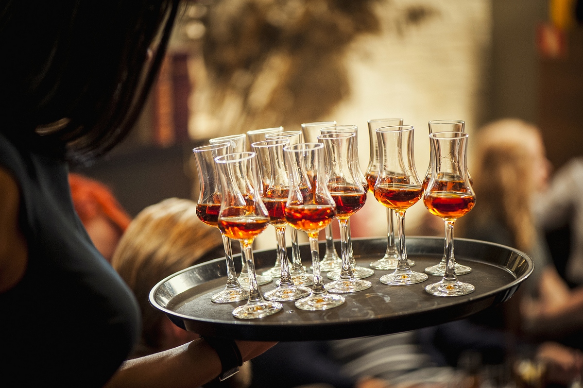 A tray of whisky pours carried through the room